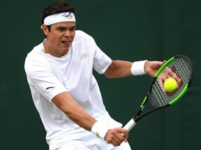 Milos Raonic plays a backhand in his fourth round match against Guido Pella during Wimbledon at the All England Lawn Tennis and Croquet Club in London, July 8, 2019.