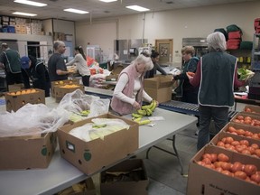 Staff and volunteers work hard at Regina food security organization REACH on Wednesday, March 25, 2020. They have been busier than ever during the COVID-19 crisis.