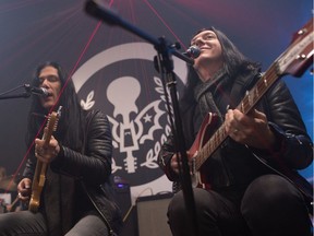 Todd Kerns (left) and Brent Fitz of the rock band Toque play for students at School of Rock Regina on March 7, 2020.