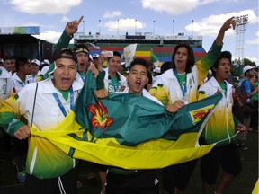 Members of Team Saskatchewan cheer during opening ceremonies at the North American Indigenous Games held at Mosaic Stadium in Regina, Sask. on Sunday July 20, 2014.