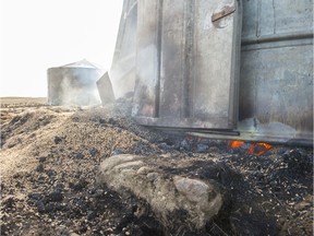 A grain bin smoulders and smokes near Burstall. The area suffered a wild fire in October 2017.