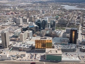 An aerial photo shows Regina's downtown including the Hill Towers, the SGI building, the SaskTel building and other well-known landmarks.