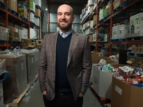 John Bailey, CEO of the Regina Food Bank, stands in the storage room of the food bank's Winnipeg Street location in Regina, Saskatchewan on December 5, 2019.