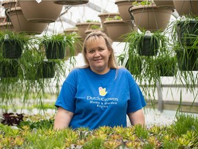 Dutch Growers Home and Garden store co-owner/operator Karen Van Duyvendyk stands in the greenhouse on Pasqua Street in Regina, Saskatchewan on March 31, 2020. The greenhouse, like many other businesses, has had to adapt how it does business in light of the COVID-19 pandemic.