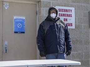 Shane Partridge, who is helping to screen homeless people looking for help at the White Buffalo Youth Lodge, outside the side enterance in Saskatoon, SK on Friday, April 3, 2020.