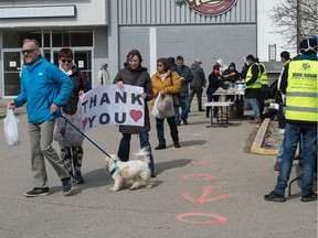 People display a sign of thanks at an event where food was being handed out to those in need by the Sikh community outside the entrance to the Rainbow Cinema on Parliament Avenue in Regina, Saskatchewan.