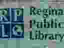 This double-exposure photograph shows a circuit board from a game console superimposed behind the Regina Public Library sign at the Central Branch in downtown Regina, Saskatchewan on April 7, 2020. The library may be using its servers to crunch COVID-19 data for scientists.
