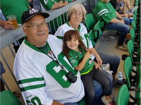 Butch Gullacher (left), his granddaughter Athena and his wife Kathleen at a Rider game. Butch is the fourth person in Saskatchewan to die from complications related to COVID-19. Photo courtesy Kathleen Gullacher.