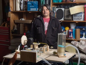 Former respiratory therapist Harry Onagi stands behind his prototype ventilator in his garage in Regina, Saskatchewan on April 15, 2020. Onagi had been working on a design years ago, which he revived and modified due to the COVID-19 pandemic. His design is meant to be built with readily available parts.