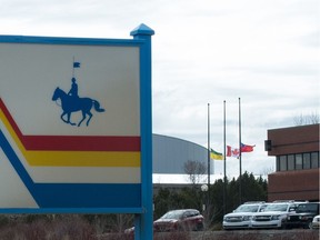 Flags hang at half-mast at the RCMP 'F' Division headquarters in Regina, Saskatchewan on April 20, 2020.
