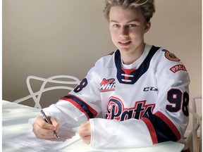 Connor Bedard, who is to be chosen first overall by the Regina Pats in Wednesday's bantam draft, is shown signing a standard player contract with the WHL team.