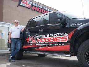 Derek Kanak, owner of Remote Control Hobbies, stands next to his truck outside his shop on Albert Street in Regina, Saskatchewan on April 22, 2020. Kanak has experienced a loss in profits due to COVID-19.