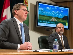 Saskatchewan Premier Scott Moe, left, and chief medical health officer Dr. Saqib Shahab talk about the government's plan to reopen the province's economy at a news conference held at the Saskatchewan Legislative Building on April 23, 2020.