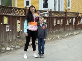 Heather Cameron and her 8-year-old son Oliver Dunn in the Alley Galley, the art gallery they've set up in the alley beside their house in Regina on Friday, April 24, 2020.