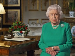 In a recent undated handout image released by Buckingham Palace on April 5, 2020 Britain's Queen Elizabeth II records her address to the UK and the Commonwealth in relation to the coronavirus epidemic at Windsor Castle, west of London. - Queen Elizabeth II urged people to rise to the challenge posed by the coronavirus outbreak, in a rare special address to Britain and Commonwealth nations on Sunday. (Photo by - / BUCKINGHAM PALACE / AFP)
