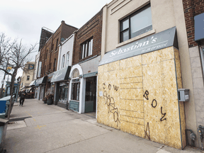A boarded-up business along Yonge Street in Toronto on April 3, 2020.