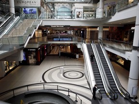 A shopper rides an escalator in the nearly empty Toronto Eaton Centre in Toronto, Ontario, Canada, on Wednesday, March 25, 2020.