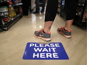 Some grocery stories in North America are putting signage on floors to make sure physical distancing is taking place.