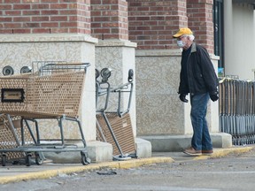 A man wearing a mask walks into the Safeway store on 13th Avenue in Regina, Saskatchewan on April 6, 2020.