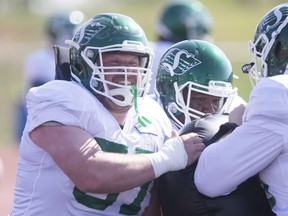 Saskatchewan Roughriders guard Brendon LaBatte, left, is shown at training camp in 2019. This year's training camp has been delayed due to COVID-19.