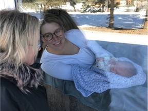Lori Newlove visits with her daughter Rylee and grandson Brooks through the front window of Rylee's home in Waldheim, SK on Wednesday, April 8, 2020.