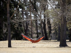 A person enjoys social distancing in a hammock in Wascana Centre in Regina on Monday, April 27, 2020.