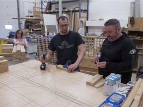 Greg Huber, right, along with Alwin Janzen build garden boxes in his shop in east Regina on May 1, 2020. Huber is part of Fanny's Furniture and Kitchens, a Regina family business that began in 1986. With the store closed due to COVID-19, he is finding new projects.