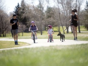 Brendan MacKenzie, left, race director of the inaugural Food Bank Virtual Run-Walk Series, goes for a run with his family — wife Nicole (far right) and daughters Lily (second from left) and Ruby. The family dog, Lexa, also joined in the fun.