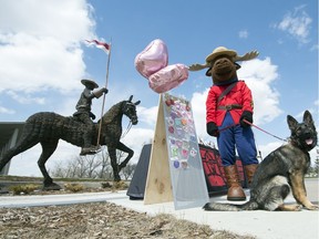 Indi, a four-month-old German shepherd, and mascot Montee stand outside the RCMP Heritage Centre in Regina on Monday, May 11, 2020. On May 13th between 10 a.m. 2 p.m., come to the RCMP Heritage Centre to pick up your own hearts for heroes.