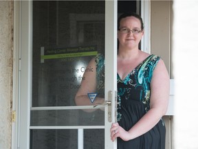 Massage therapist Laura Kautz stands at the door of her home in Regina, Saskatchewan on May 15, 2020. Kautz has an autoimmune disorder, so she is concerned about re-opening her business during the COVID-19 pandemic.