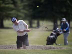 Garth Jessup hits his ball out of a sand trap at the Tor Hill Golf Course on Friday.