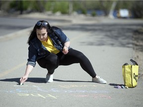 Brittany Happy writes  inspiring and cheerful messages in chalk on the path around Wascana Lake, and on other paved surfaces in Regina.