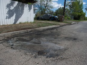 An apparent charred spot on the pavement is pictured on 13th Avenue near Embury Street in Regina, Saskatchewan on May 27, 2020. Police notified the media that a deceased person had been found in a vehicle that burned in the area, but would not confirm whether the blackened pavement shown in this photograph is located at the site of the fire. Police came across the burning vehicle at approximately 5:30 a.m. on May 27, 2020.  BRANDON HARDER/ Regina Leader-Post