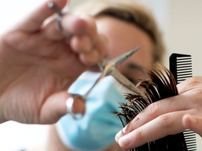 Hair stylists are wearing masks as a precautionary measure due to the COVID-19 pandemic.