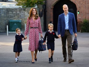Britain's Princess Charlotte of Cambridge, accompanied by her father, Prince William, Duke of Cambridge, her mother, Catherine, Duchess of Cambridge and brother, Prince George of Cambridge, arrives for her first day of school at Thomas's Battersea in London on Sept. 5, 2019.