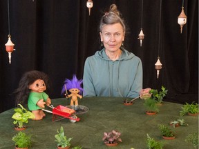 Robin Poitras, artistic director of New Dance Horizons, sits behind one of the "tiny worlds" displays created for NDH's Stream of Dance festival. The piece, entitled "SHERWOOD GARDEN / HAPPY MOTHER'S DAY!" was created by Robin Poitras and features small tropical plants from Sherwood Greenhouse &  Gardencentre Ltd. It also features a tiny wheelbarrow and shovel by Dick Moulding and ornamental bird houses by Paul Omilon.