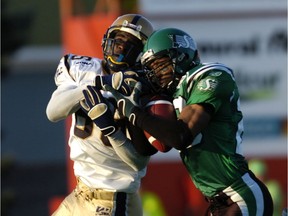 The Roughriders' Eddie Davis, right, intercepts a pass intended for the Winnipeg Blue Bombers' Milt Stegall in 2005.