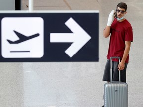 A passenger wearing a protective face mask waits for his flight at Fiumicino Airport, one of the two airports in the world to obtain the 'Biosafety Trust certification' for the correct application of security measures to prevent infections, following the coronavirus disease (COVID-19) outbreak, in Rome, Italy June 30, 2020.
