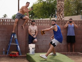SCOTTSDALE, ARIZONA - JUNE 05: MLB pitcher Jakob Junis with the Kansas City Royals throws a pitch from a makeshift mound in front of Seth Blair with the San Diego Padres, trainer Seth Lintz and Danny Hultzen with the Chicago Cubs during a back yard training session on June 05, 2020 in Scottsdale, Arizona. Since the MLB season was paused indefinitely due to the coronavirus COVID-19 pandemic, players have been using the back yard at Seth Blairs' house to train and work on mechanics.