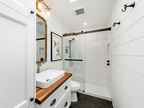 The mix of contrasting neutrals and textures, such as the white and black tile and the warm wood vanity top, are just a few ideas to get your creative juices going as you plan your next home renovation project.