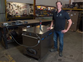 Sean Frisky, CEO of Ground Effects Environmental Services Inc., stands with the SANOZONE prototype in the Ground Effects shop on Industrial Drive in Regina, Saskatchewan on June 3, 2020. The machine is designed decontaminate spaces using ozone technology. Early tests show it to be effective on COVID-19.