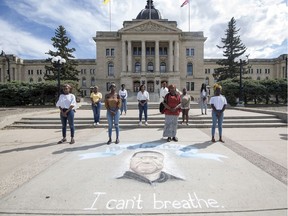 Members of the group Black in Sask, which is organizing a Sunday rally stand with Muna De Ciman, an organizer of the Friday BLM-African communities unite rally, out front of the Legislative Building near the chalk drawing of George Floyd in Regina on Thursday, June 4, 2020.