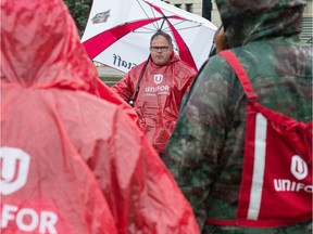 Unifor 594 president Kevin Bittman, centre, speaks to members of his local in front of the Saskatchewan Legislative Building in Regina, Saskatchewan on June 18, 2020. Earlier in the day, it was announced the union had reached a tentative deal to end a lockout that began in December 2019.