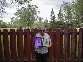 Yvonne Bigknife, Ryan Sugar's kokum, holds two memorial pictures of her deceased grandson in Regina, Wednesday, June, 24, 2020. Ryan's body was found inside a burned-out house, the result of a homicide, in October 2016. Two people have since been convicted of murder in the death.