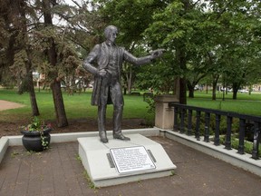 A new piece of signage is visible at the foot of the John A. Macdonald statue in Victoria Park in Regina, Saskatchewan on June 30, 3020. The sign indicates the city's knowledge that the statue represents a harmful legacy to members of the community.