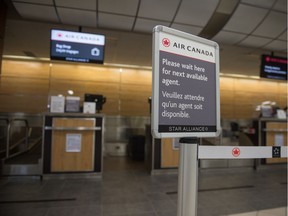 An Air Canada check-in counter sits empty in the Regina International Airport in Regina, Saskatchewan on June 30, 2020.