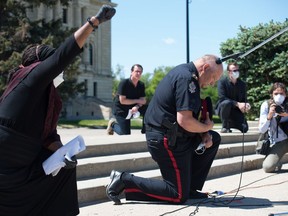 Regina Police Chief Evan Bray kneels during a Black Lives Matter rally that went from the Royal Saskatchewan Museum to the Saskatchewan legislative Building in Regina, Saskatchewan on June 5, 2020.