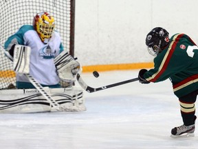 Tye Luffman of the Wild shoots against Barons goaltender Matish Andrew during a Hockey Regina pee wee tier 2 game on March 21, 2013.