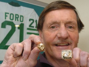 Former Roughriders player and general manager Alan Ford, pictured here in 2020, with his two Grey Cup rings from 1966 and 1989.