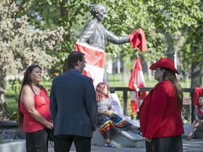 Mayor Michael Fougere meets with Kerry Bellegarde-Opoonechaw, left, and Star Andreas, right, at the John A. Macdonald statue in Victoria  Park in Regina on Friday, July 3, 2020.